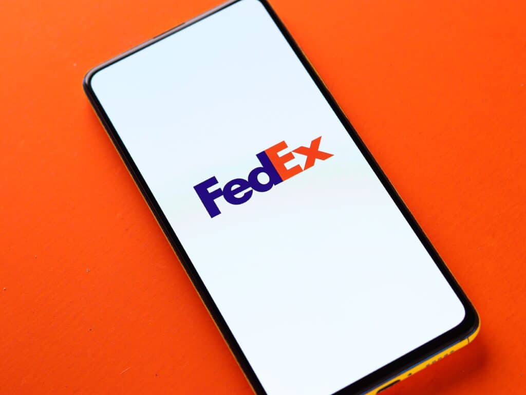Fedex Logo on mobile phone with orange background